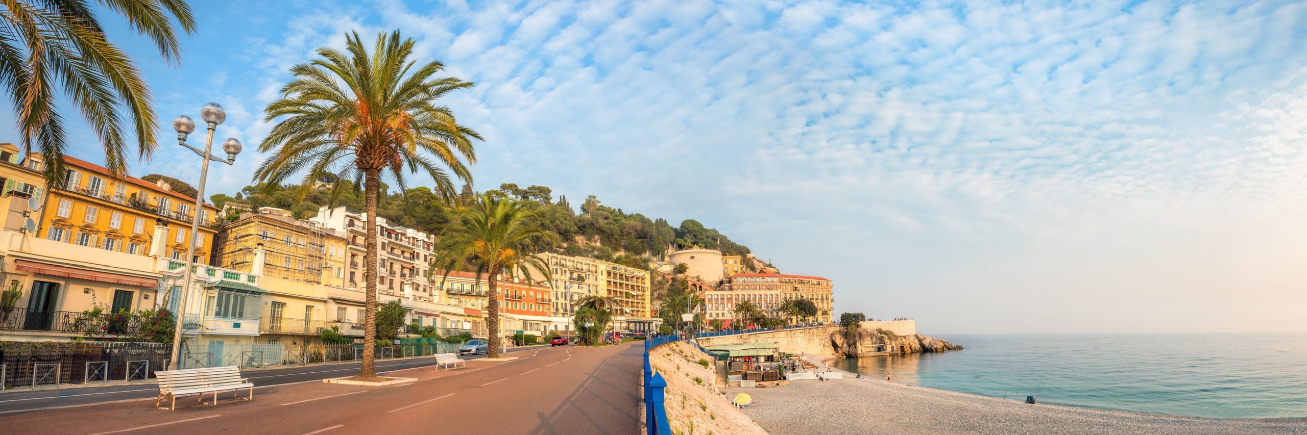 Panoramic view of beach and Promenade des Anglais at sunset in Nice. Cote d'Azur, France