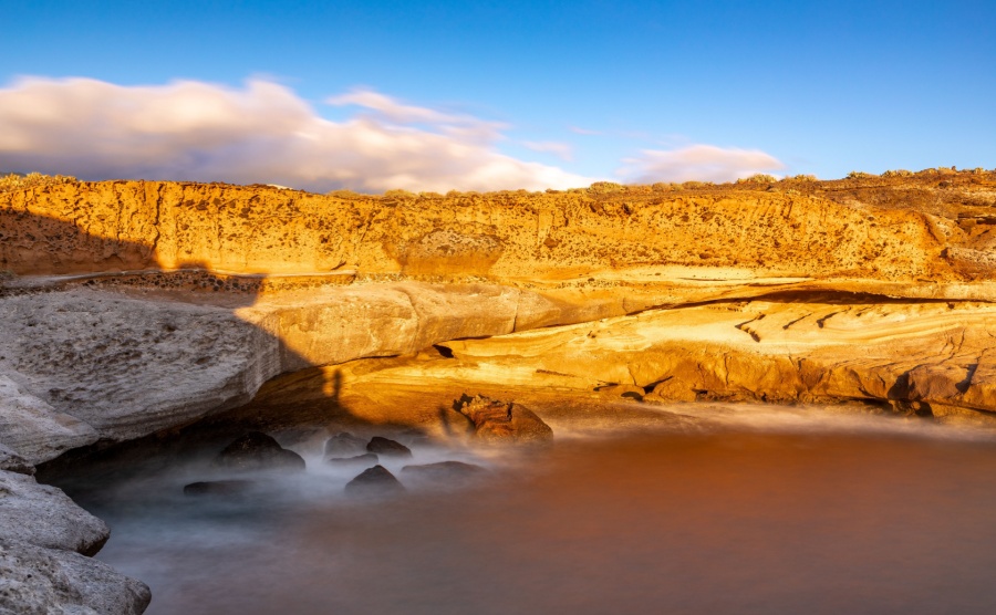 Coast of Playa Puertito near Costa Adeje, Tenerife, Spain in the light oft he setting sun.