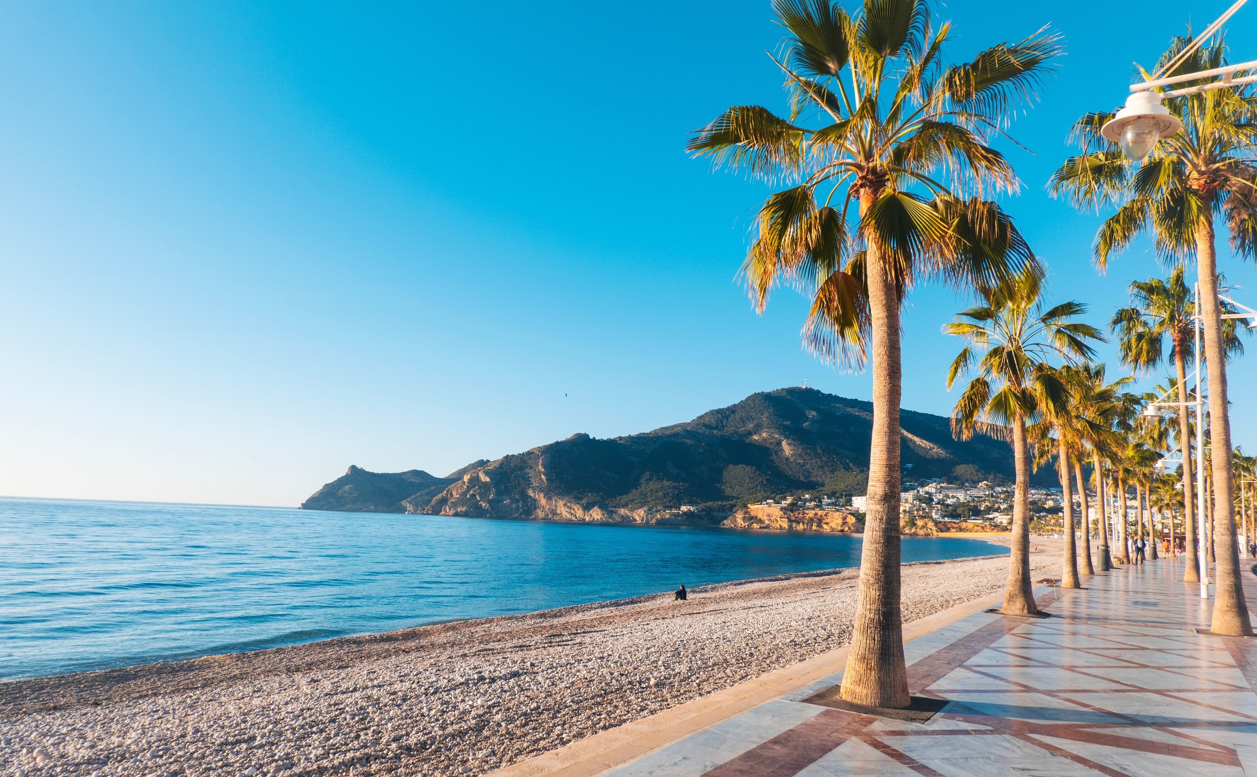 View to beautiful Albir town with main boulevard promenade, seaside beach and Mediterranean sea. Albir is small resort city between Altea and Benidorm, Alicante province, Spain. 