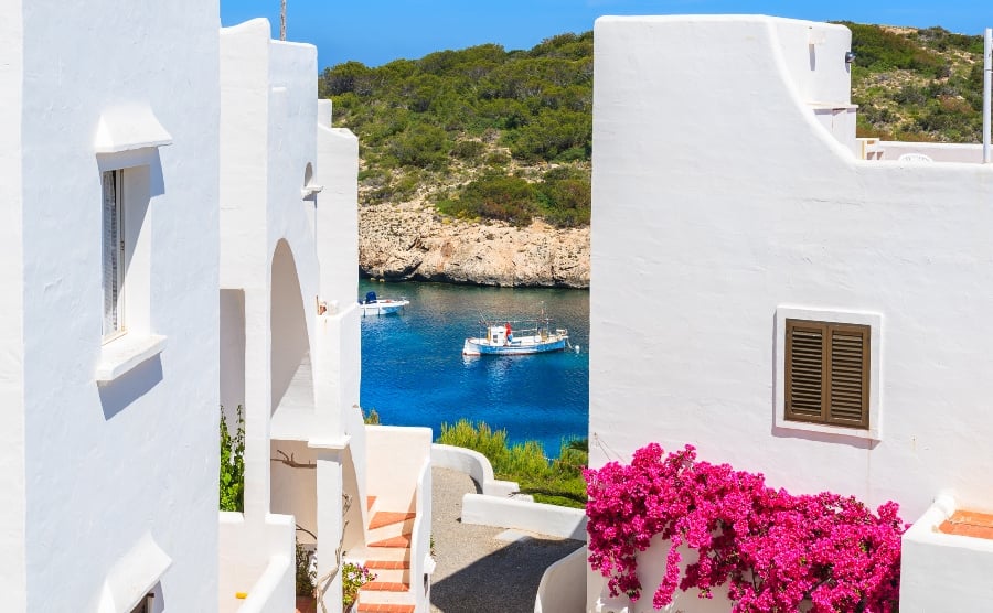 Traditional white houses overlooking Cala Portinatx bay, Ibiza