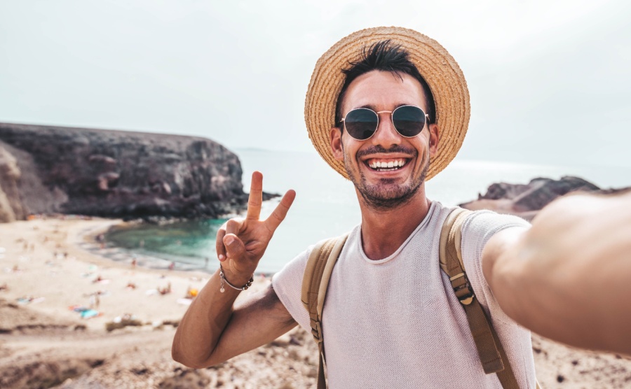 A man takes a selfie on the beach