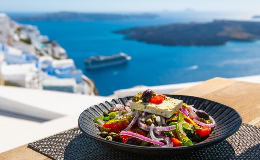 Greek salad with sea in background