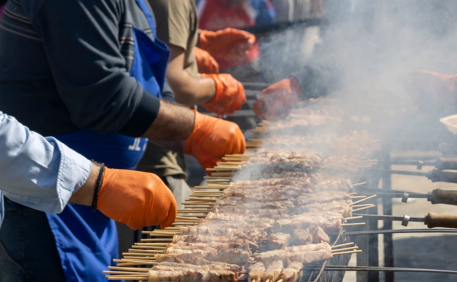 A line of cooks making souvlaki