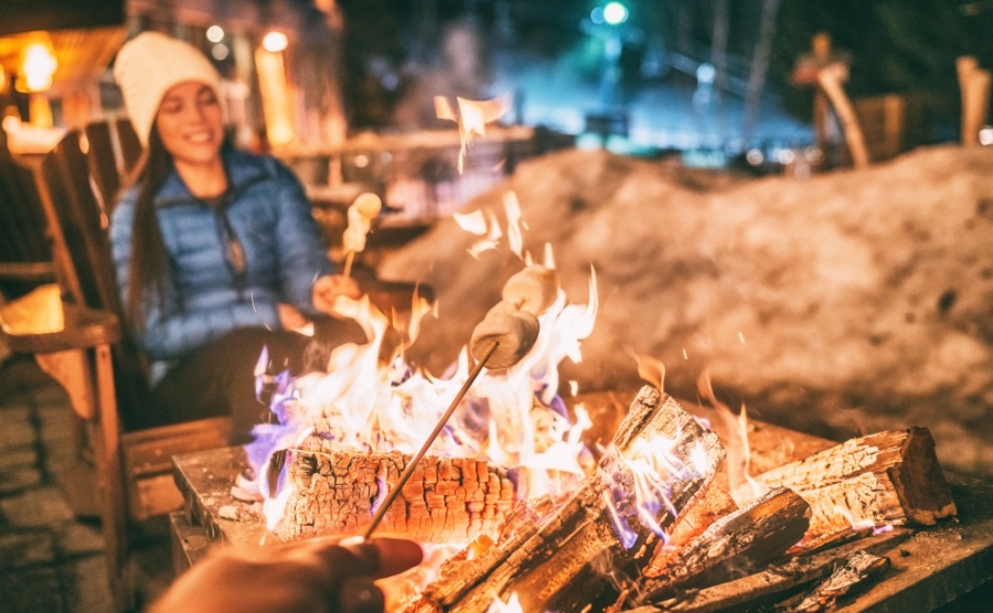 Friends enjoying marshmallows cooked over an open fire