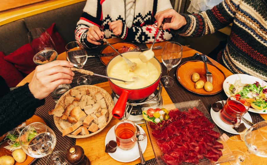 Friends enjoying cheese fondue