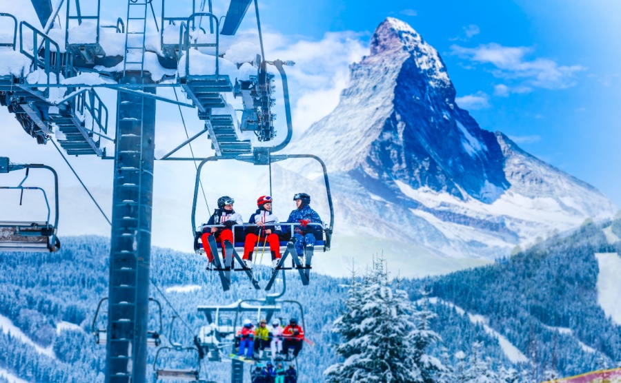 Skiers on a lift up to the Zermatt ski area