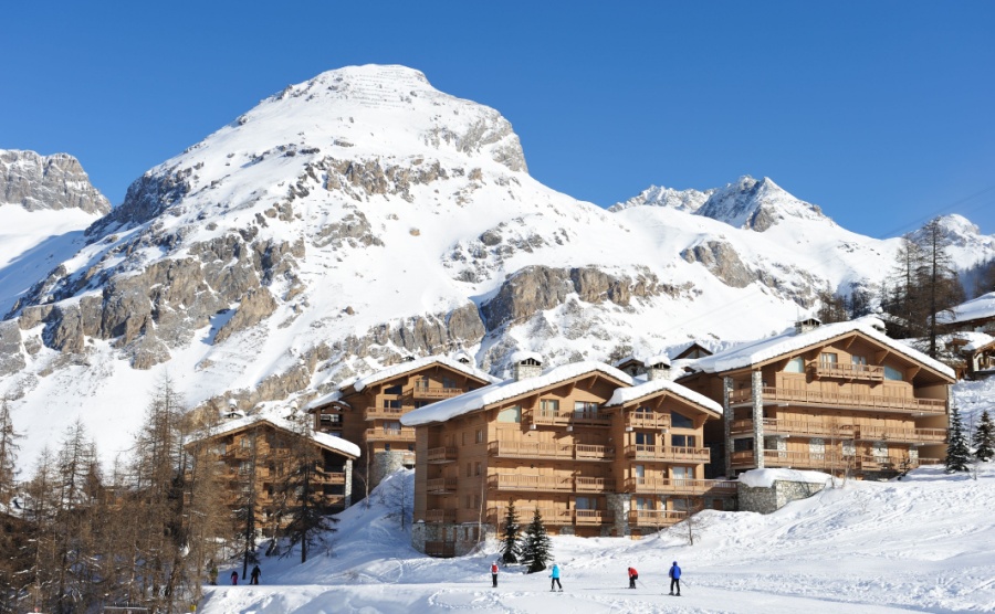 Ski chalets in front of a mountain in the alps