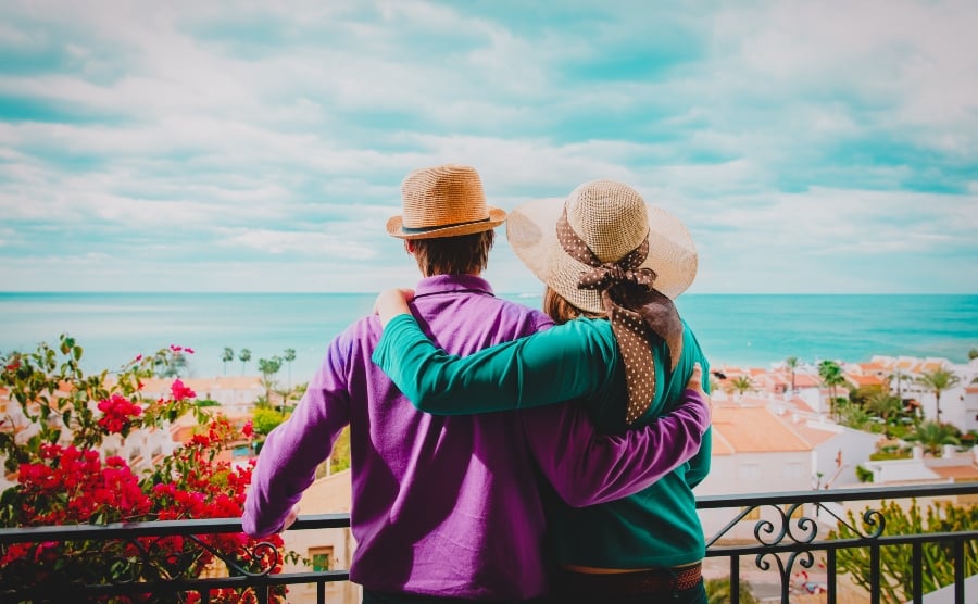 Couple hugging on a balcony