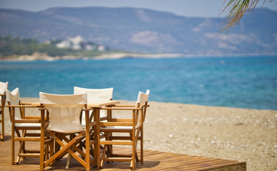 Restaurant chairs on a sunny beach in Paphos