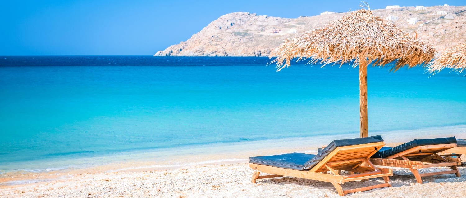 Mykonos beach with sunloungers and umbrellas