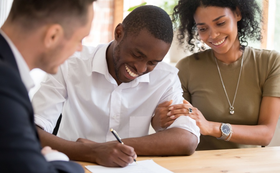 A family signing a house contract