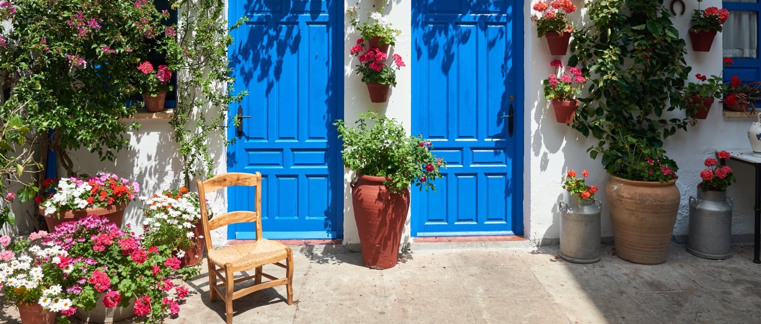 Chair outside two blue doors