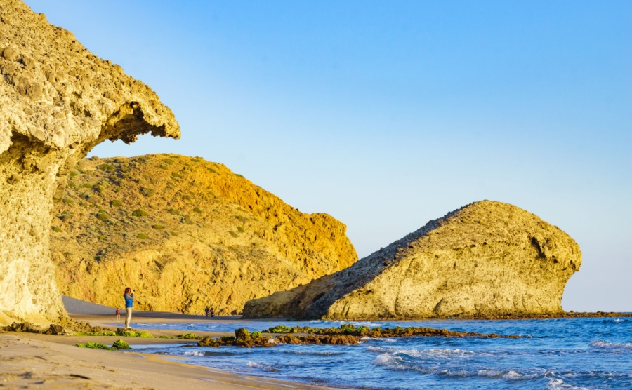 People walking on Monsul beach in Cabo de Gata Nijar Natural Park. 