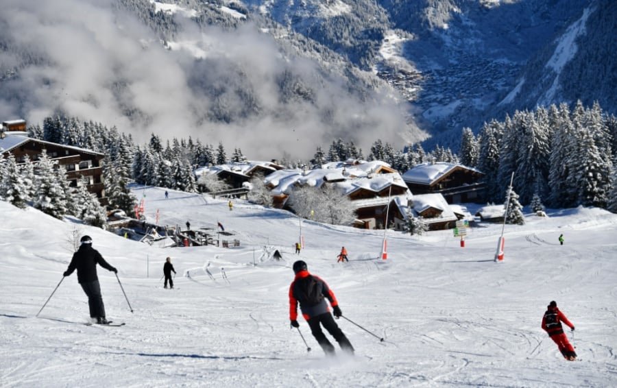 A skier skis toward Courchevelle